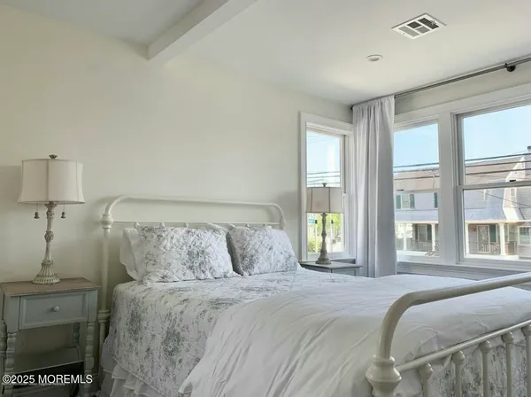 a bedroom with a bed and a night stand