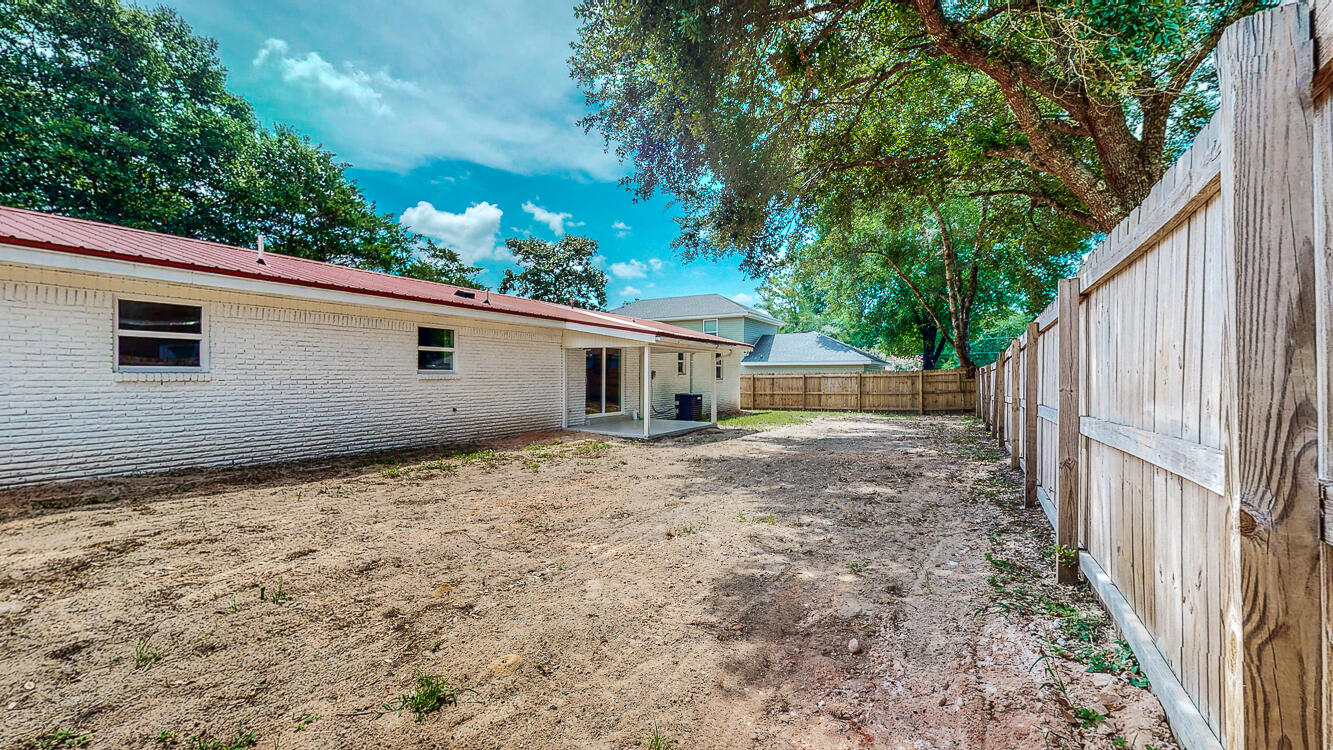 166 Patch Avenue Crestview, FL 32539 - Photo 12 of 48 a backyard of a house with plants and tree