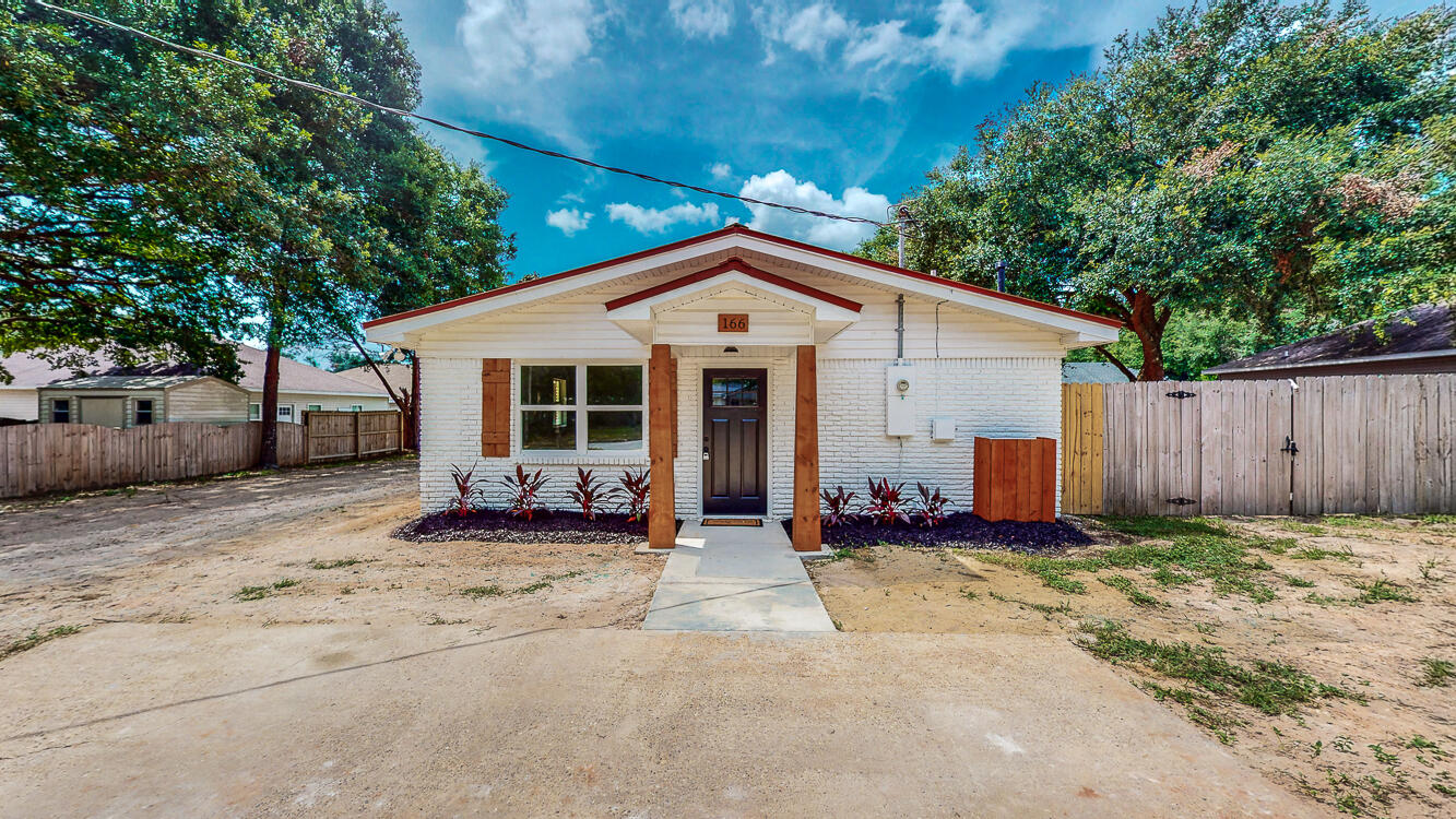 166 Patch Avenue Crestview, FL 32539 - Photo 15 of 48 a front view of a house with a yard outdoor seating and garage