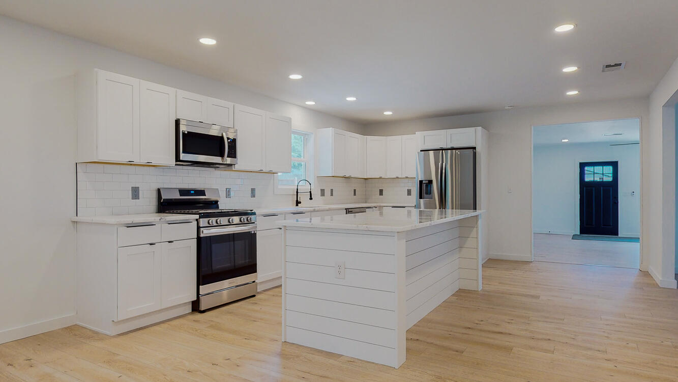 166 Patch Avenue Crestview, FL 32539 - Photo 20 of 48 a large white kitchen with stainless steel appliances granite countertop a stove a sink and a refrigerator