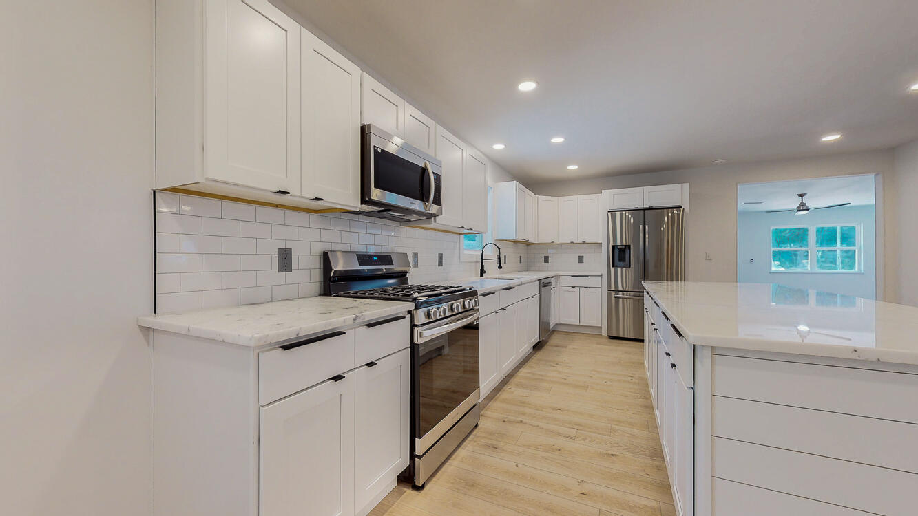 166 Patch Avenue Crestview, FL 32539 - Photo 21 of 48 a kitchen with stainless steel appliances granite countertop a sink and dishwasher a stove top oven with wooden floor