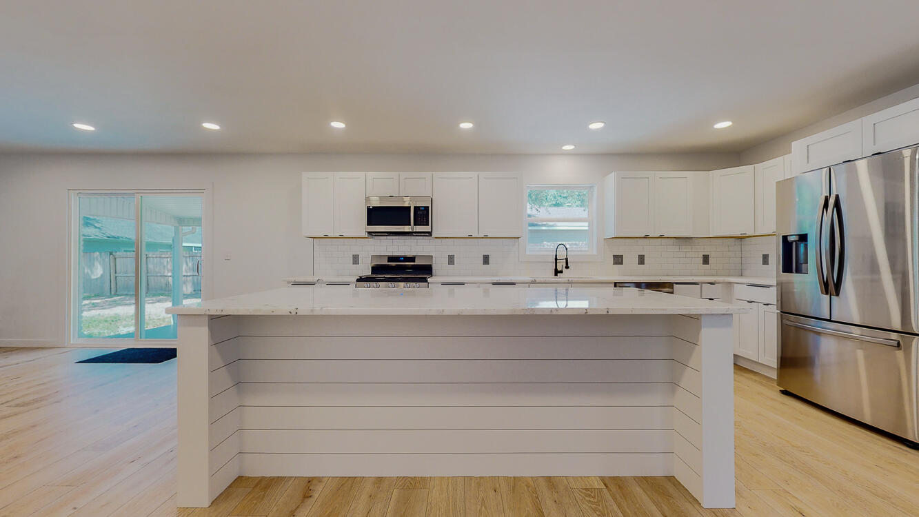 166 Patch Avenue Crestview, FL 32539 - Photo 23 of 48 a kitchen with stainless steel appliances refrigerator and microwave