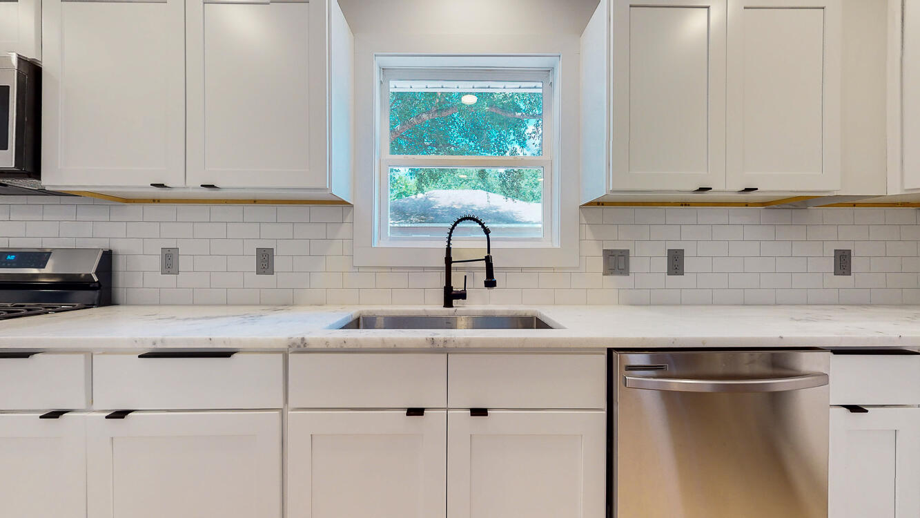 166 Patch Avenue Crestview, FL 32539 - Photo 29 of 48 a kitchen with stainless steel appliances granite countertop a sink a window and cabinets