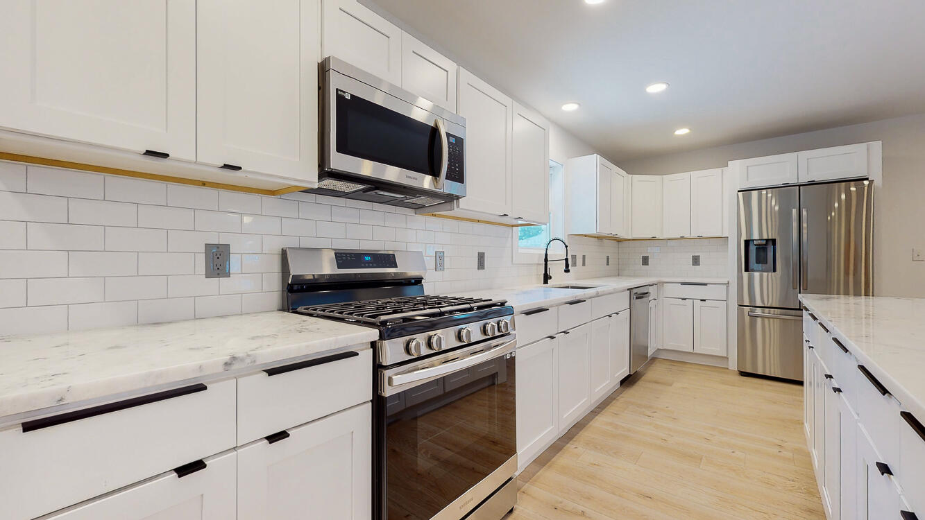 166 Patch Avenue Crestview, FL 32539 - Photo 30 of 48 a kitchen with cabinets stainless steel appliances and wooden floor