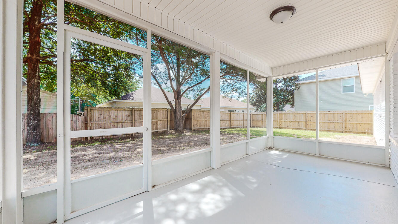 166 Patch Avenue Crestview, FL 32539 - Photo 4 of 48 a view of a porch with furniture and floor to ceiling window