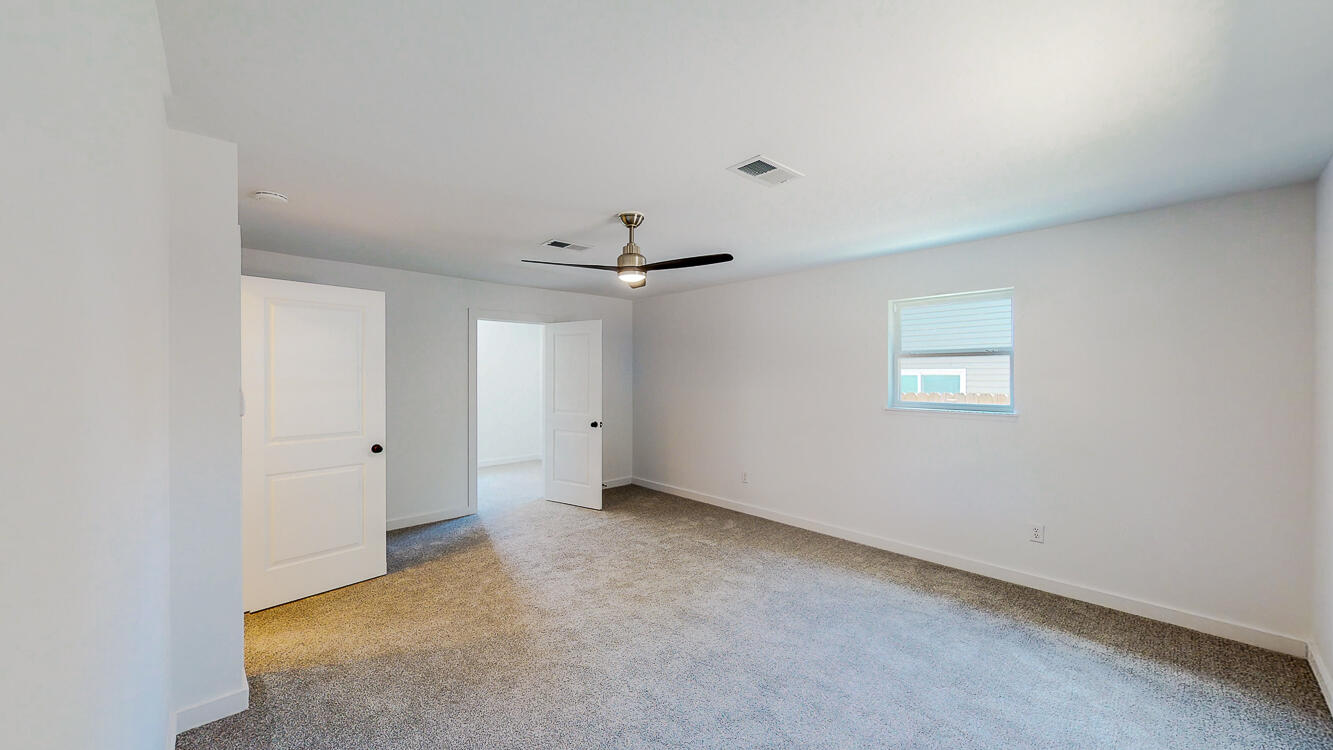 166 Patch Avenue Crestview, FL 32539 - Photo 47 of 48 an empty room with a ceiling fan and a window
