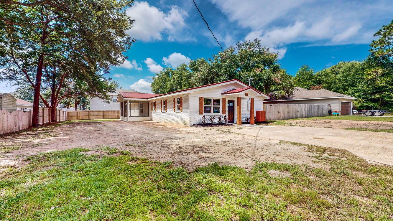 166 Patch Avenue Crestview, FL 32539 - Photo 9 of 48 a front view of a house with a yard