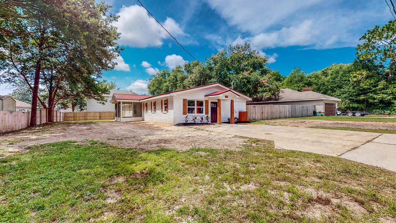 166 Patch Avenue Crestview, FL 32539 - Photo 10 of 48 a front view of a house with a garden