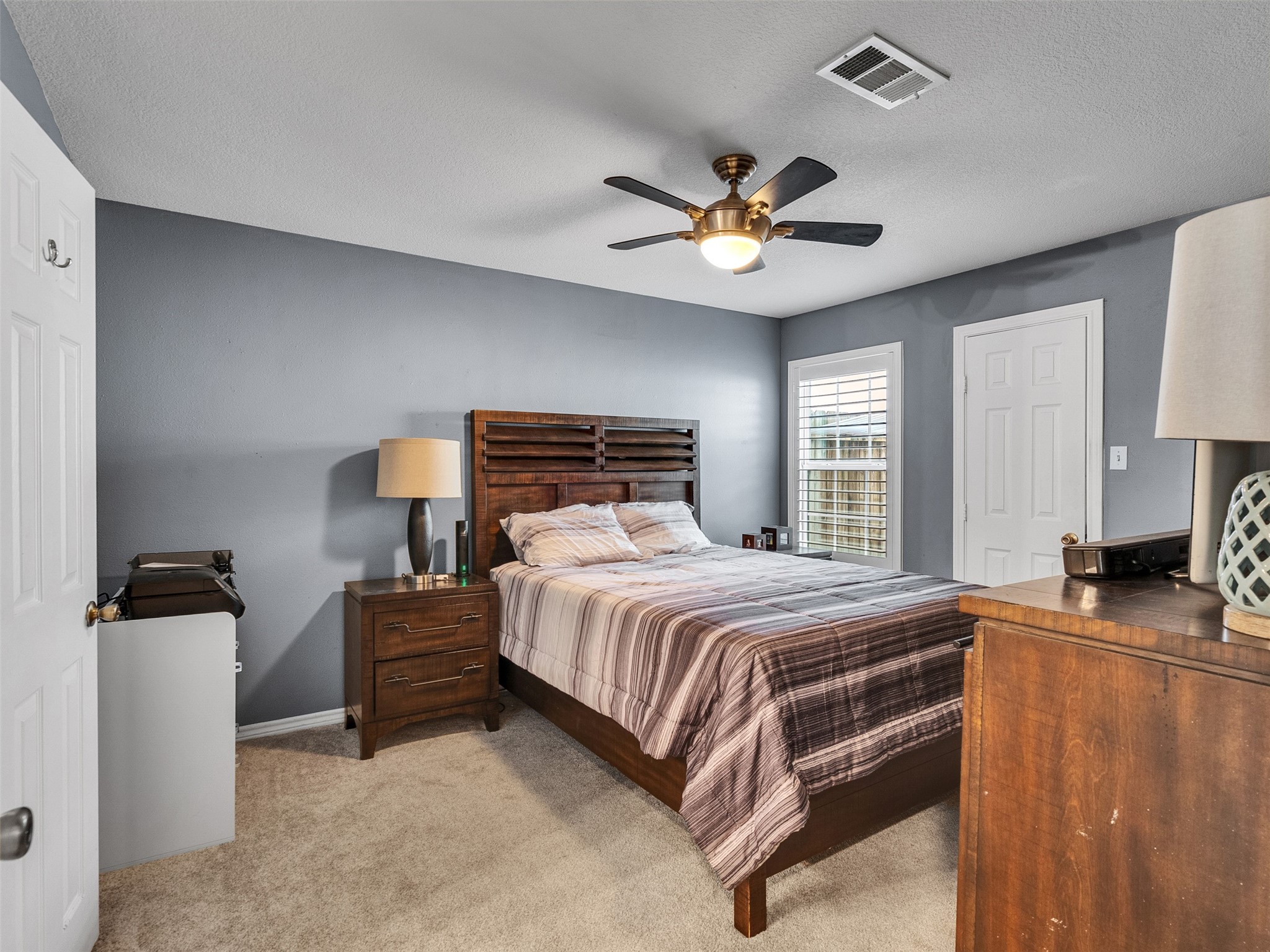 10109 Schaper Road Galveston, TX 77554 - Photo 12 of 33 a bedroom with a bed and a chandelier