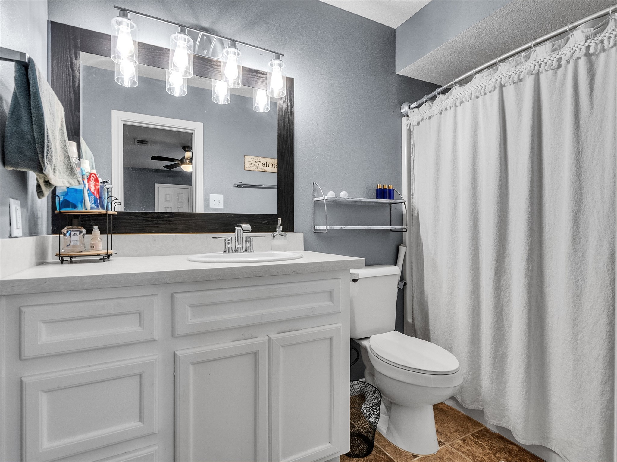 10109 Schaper Road Galveston, TX 77554 - Photo 14 of 33 a bathroom with a toilet a sink and a mirror