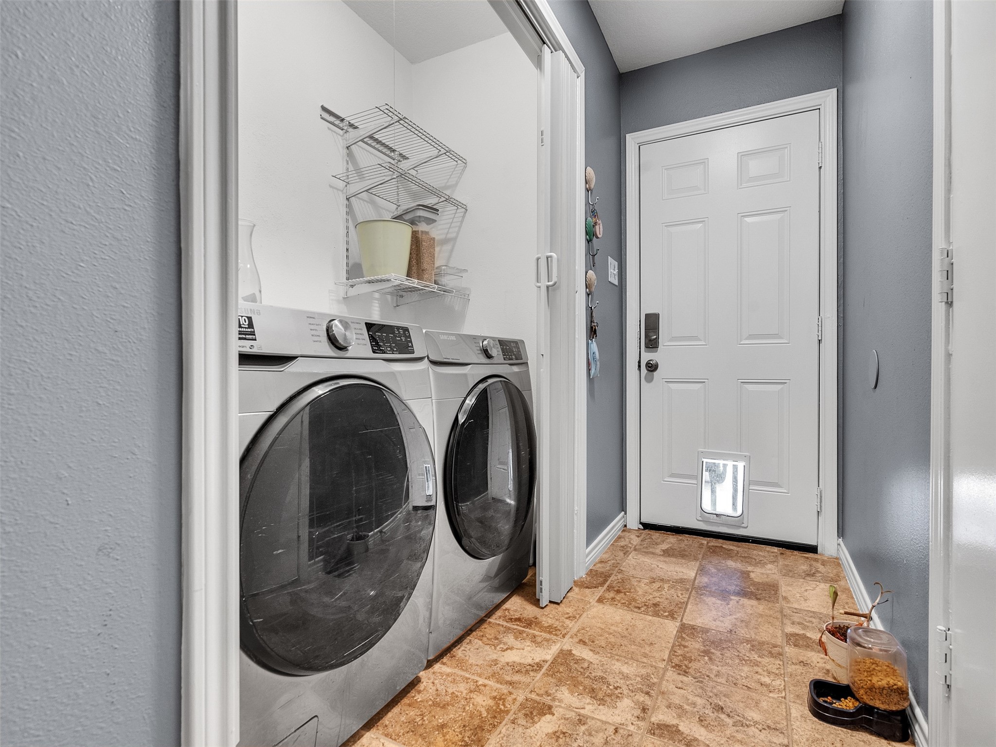10109 Schaper Road Galveston, TX 77554 - Photo 16 of 33 a view of a storage & utility room with a washer and dryer
