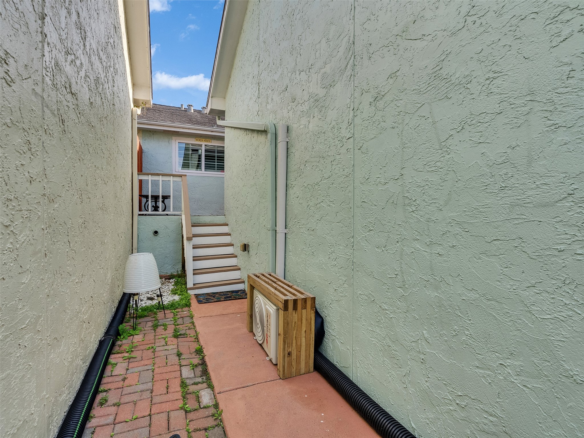 10109 Schaper Road Galveston, TX 77554 - Photo 19 of 33 Another view of the side walkway highlights privacy and smooth access from the outdoor spaces. Functional, neat, and ready for your personal touches!