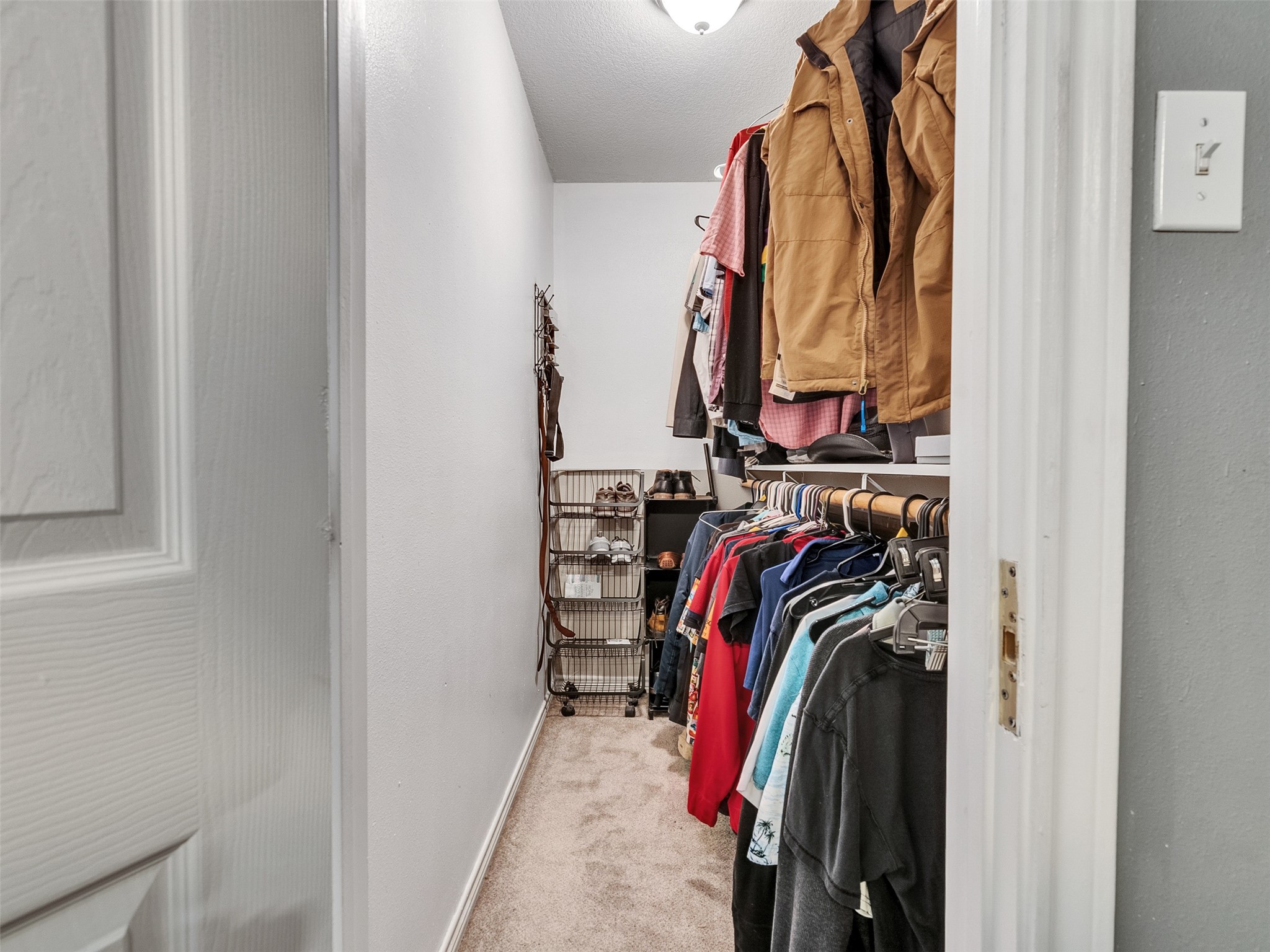 10109 Schaper Road Galveston, TX 77554 - Photo 28 of 33 a view of walk in closet with clothes