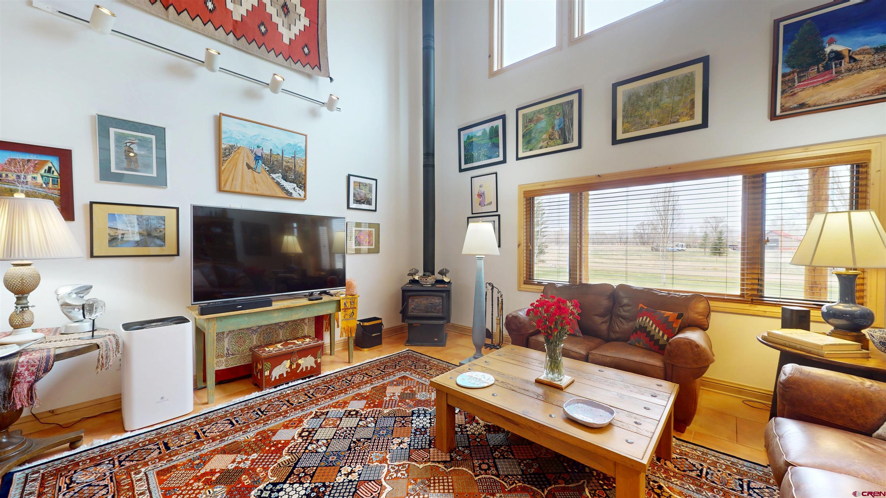 157 Spring Meadow Trail Gunnison, CO 81230 - Photo 15 of 43 Wood burning stove allows for additional source of heat. Faux wood blinds throughout the home.