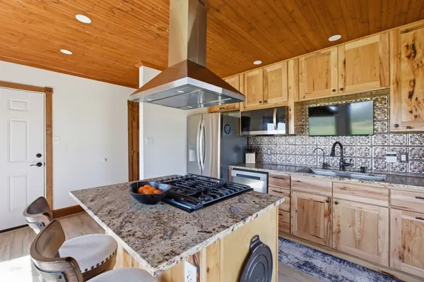 a kitchen with sink stove and cabinets