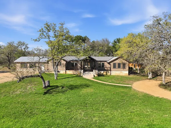 a front view of a house with a yard table and chairs