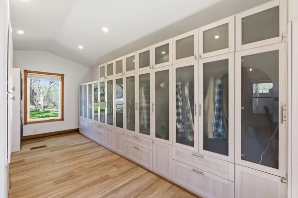 a view of wooden floor and windows in a room