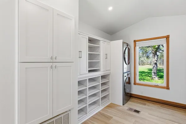 a view of walk in closet with empty racks
