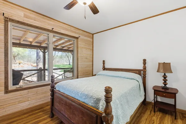 a bed sitting in a bedroom next to a window