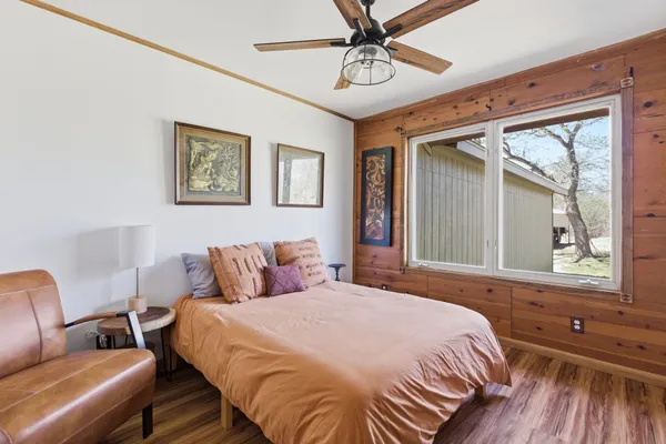 a bedroom with a bed and wooden floor