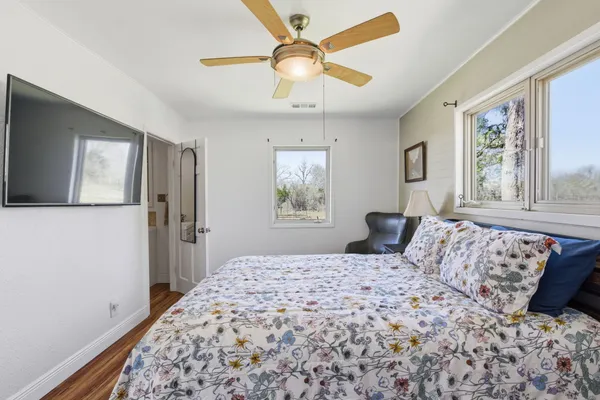 a bedroom with a large bed and a window