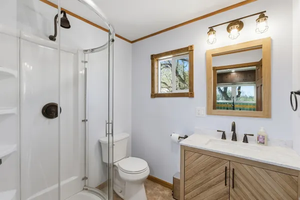 a bathroom with a sink toilet and shower