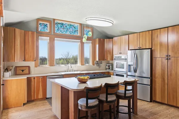 a kitchen with stainless steel appliances a stove a sink and a refrigerator