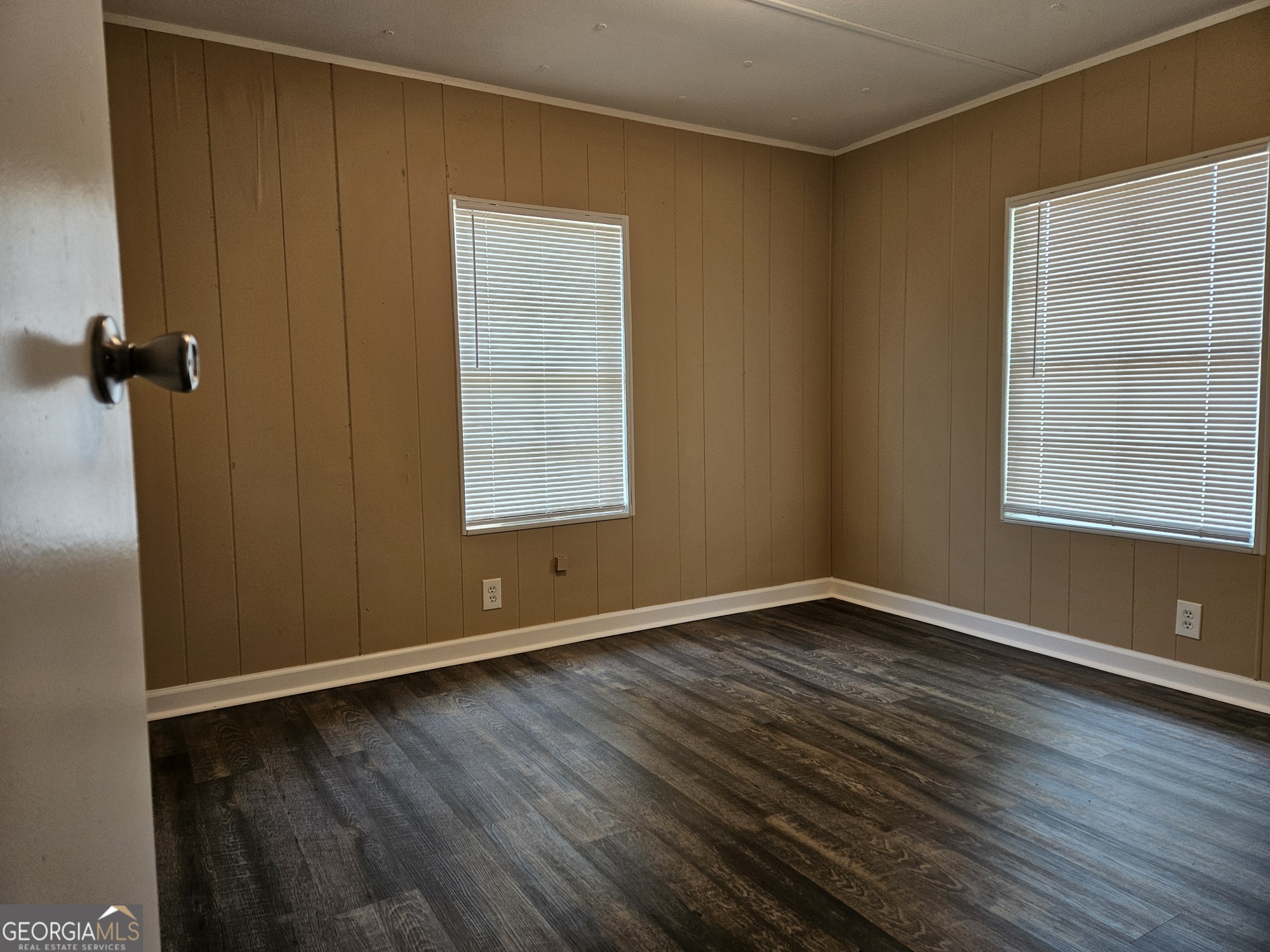 647 Buck Creek Road Sylvania, GA 30467 - Photo 13 of 16 an empty room with wooden floor and windows