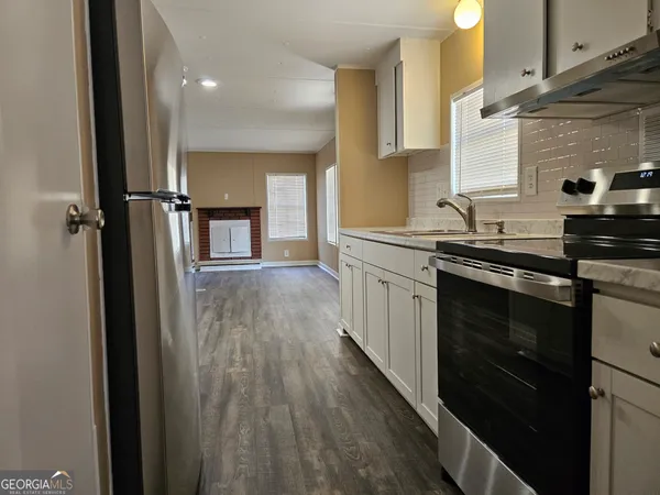 a kitchen with a sink a stove and refrigerator