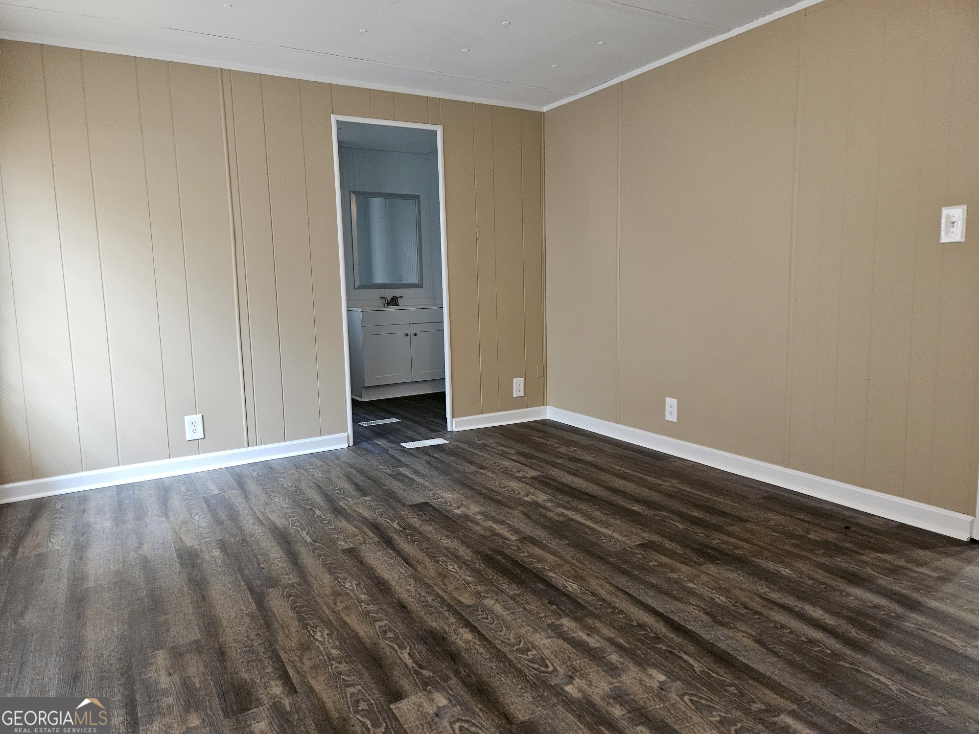 647 Buck Creek Road Sylvania, GA 30467 - Photo 7 of 16 a view of an empty room with wooden floor