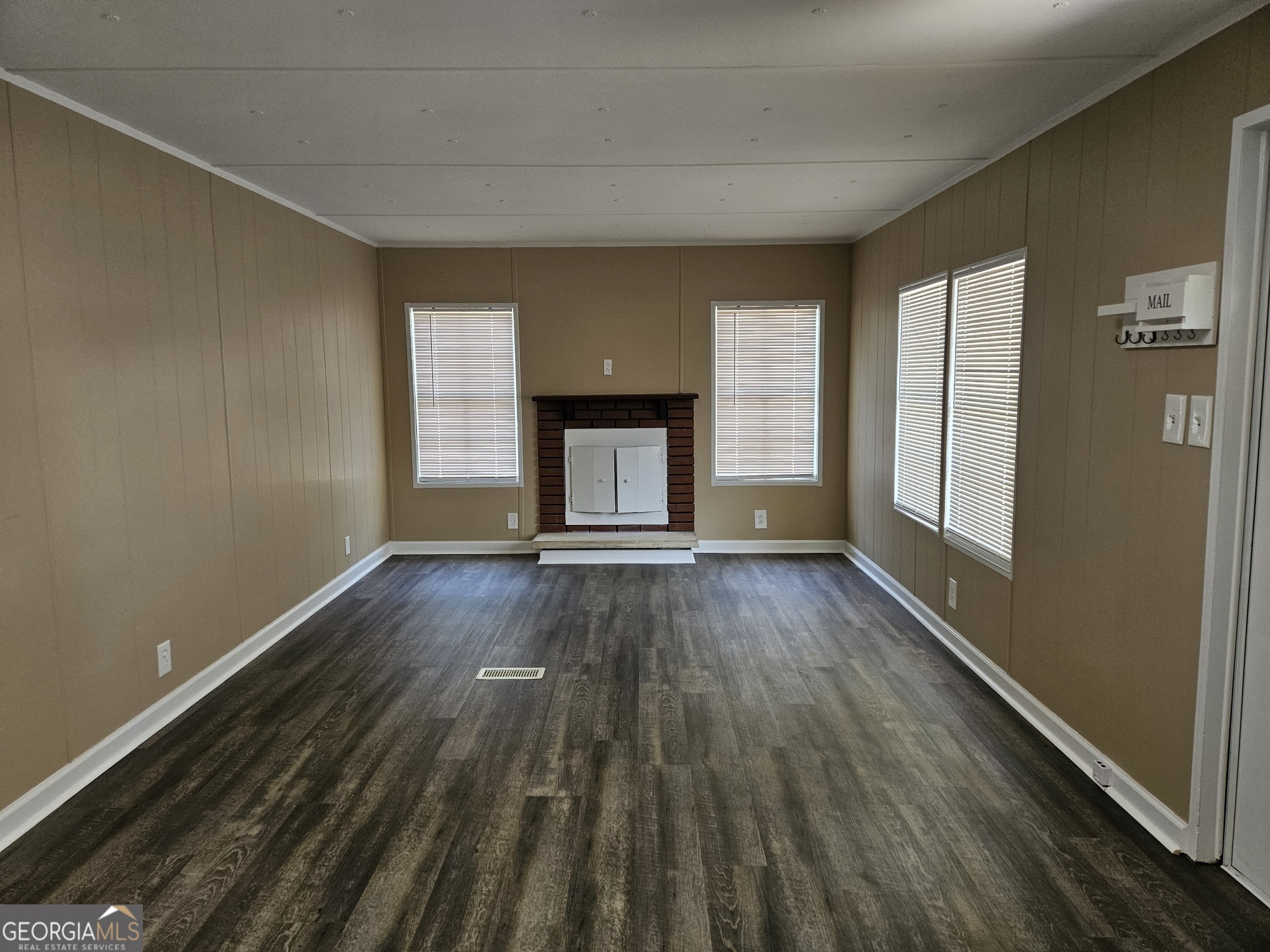 647 Buck Creek Road Sylvania, GA 30467 - Photo 10 of 16 a view of an empty room with wooden floor and a window