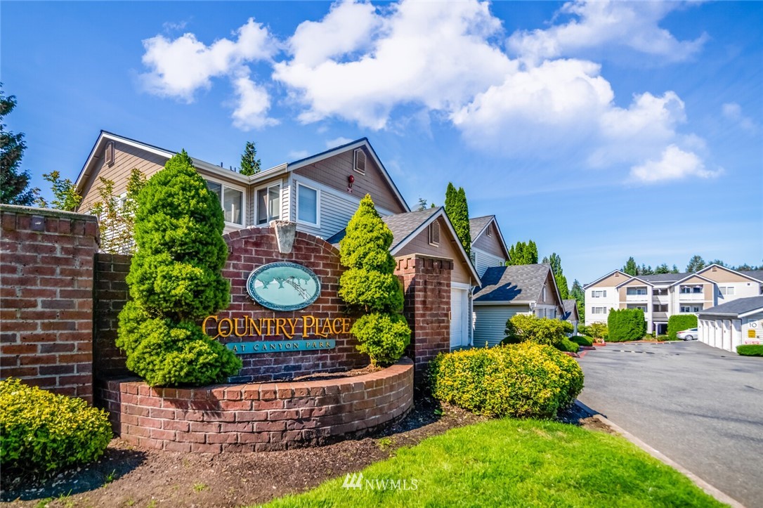 23908 Bothell Everett Highway, Unit A103 Bothell, WA 98021 - Photo 1 of 20 a front view of a house with garden
