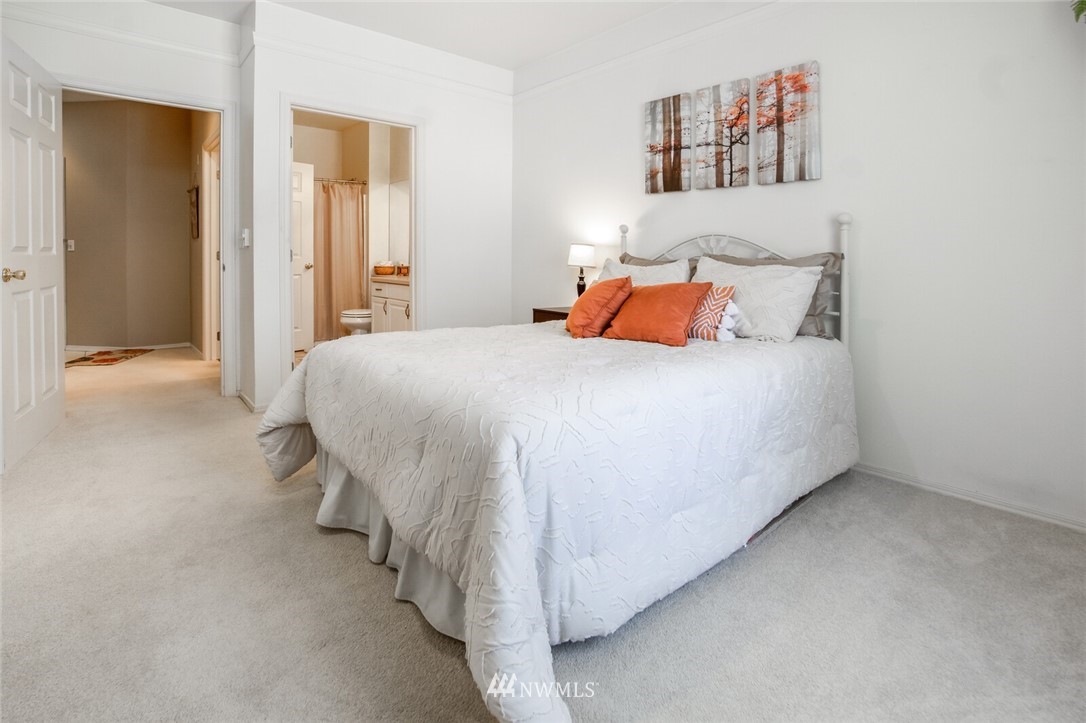 23908 Bothell Everett Highway, Unit A103 Bothell, WA 98021 - Photo 14 of 20 a bedroom with a bed and a night stand