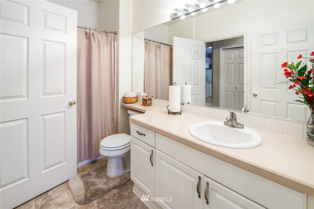 23908 Bothell Everett Highway, Unit A103 Bothell, WA 98021 - Photo 15 of 20 a bathroom with a toilet sink and mirror