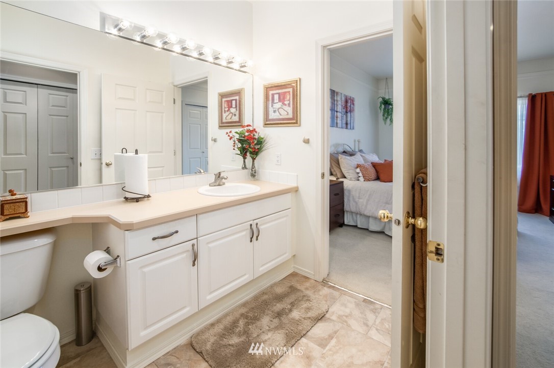 23908 Bothell Everett Highway, Unit A103 Bothell, WA 98021 - Photo 16 of 20 a spacious bathroom with a double vanity sink mirror and toilet
