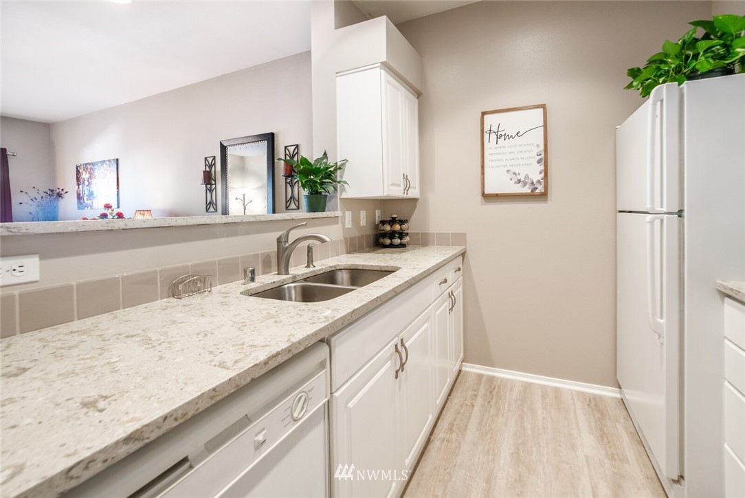 23908 Bothell Everett Highway, Unit A103 Bothell, WA 98021 - Photo 4 of 20 a kitchen with a sink and a refrigerator