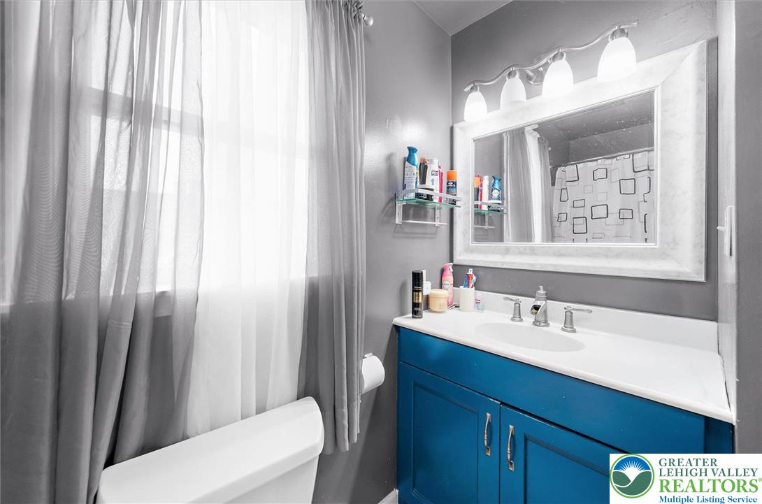 326 Chestnut Street Slatington, PA 18080 - Photo 19 of 28 a bathroom with a sink a toilet and shower curtain