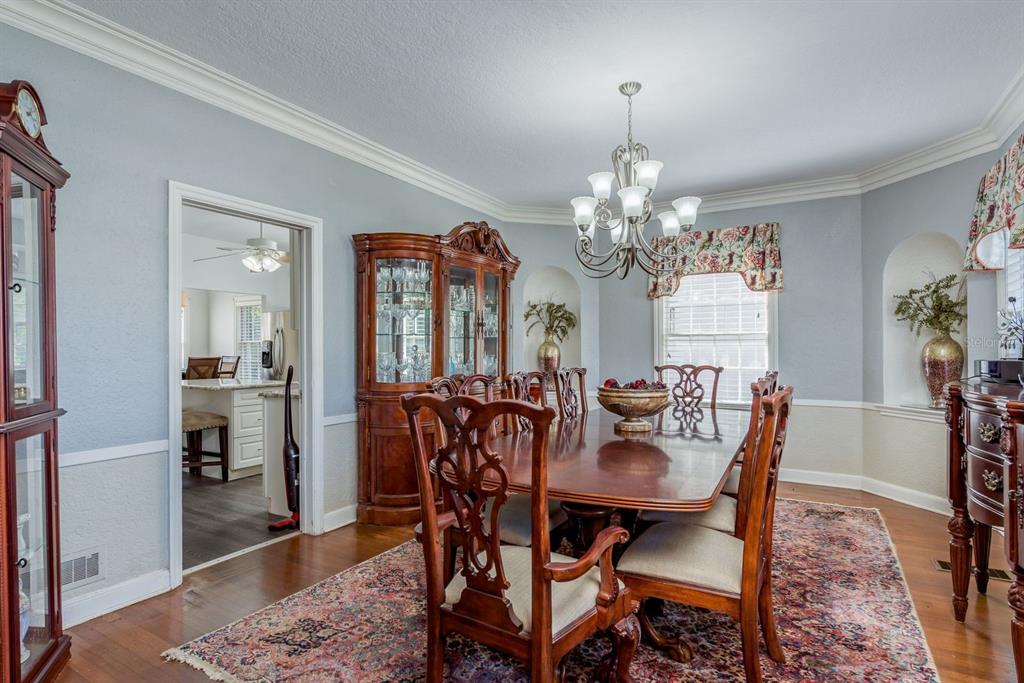 1111 West Line Street Leesburg, FL 34748 - Photo 11 of 77 a view of a dining room with furniture and wooden floor