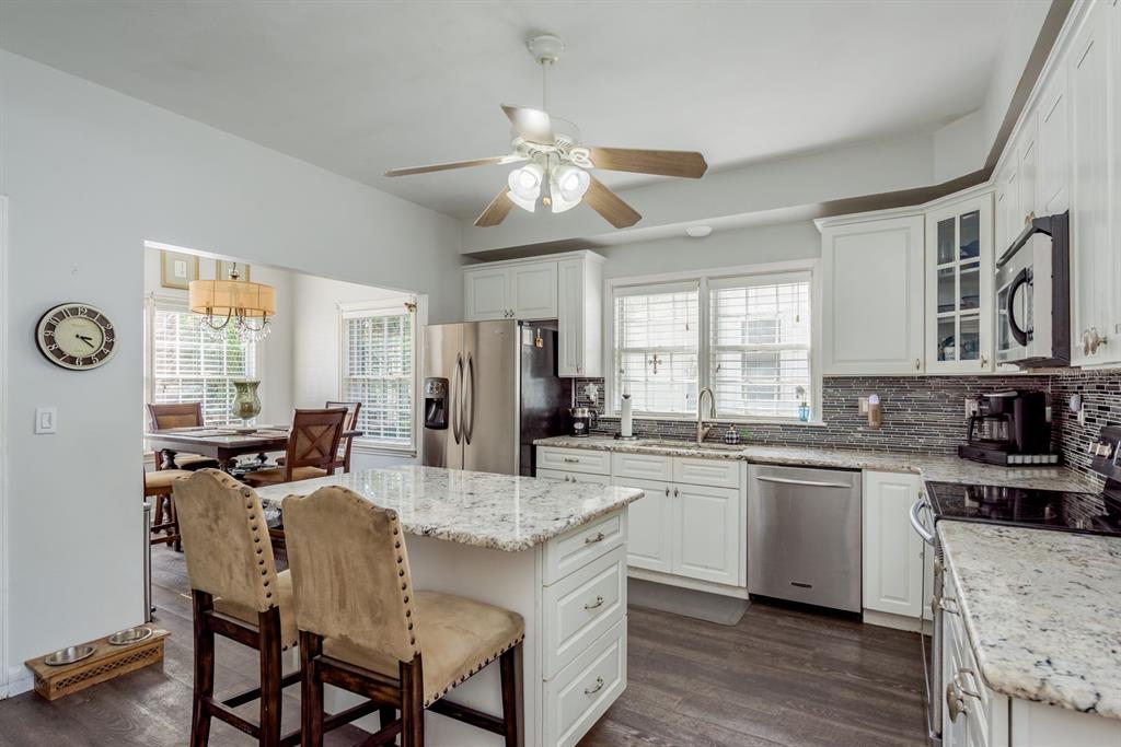 1111 West Line Street Leesburg, FL 34748 - Photo 12 of 77 a kitchen with granite countertop lots of counter top space and stainless steel appliances