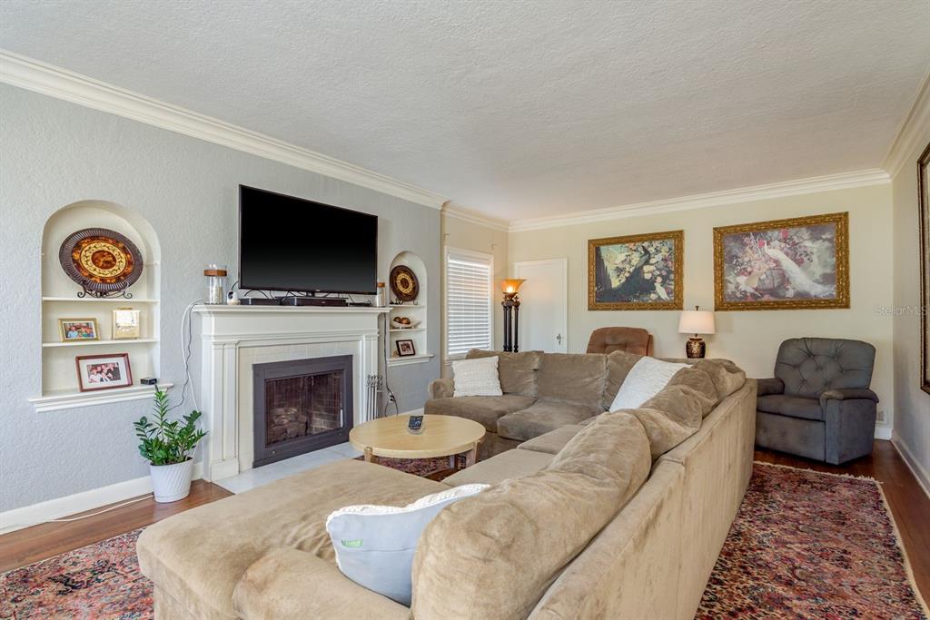 1111 West Line Street Leesburg, FL 34748 - Photo 18 of 77 a living room with furniture a flat screen tv and a fireplace