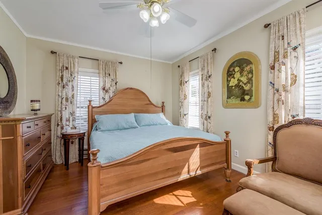 a spacious bedroom with a bed and a chandelier