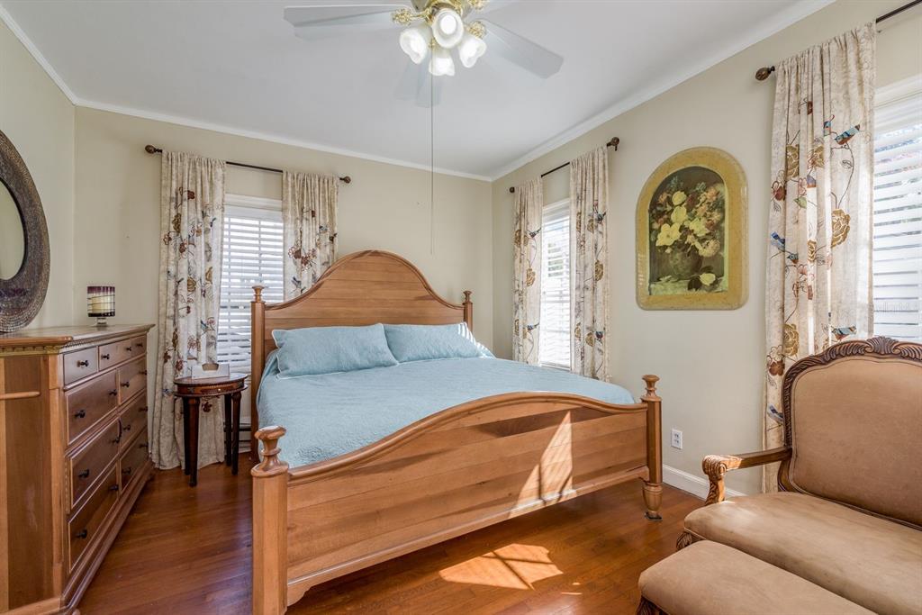 1111 West Line Street Leesburg, FL 34748 - Photo 21 of 77 a bedroom with a bed and a chandelier