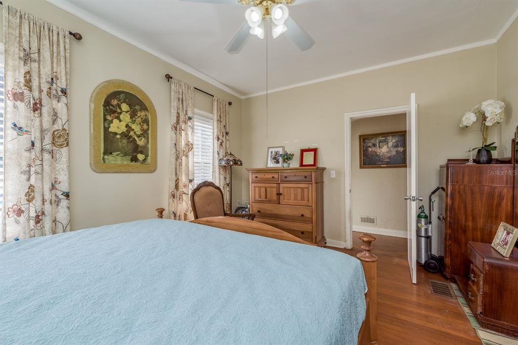 1111 West Line Street Leesburg, FL 34748 - Photo 22 of 77 a bedroom with a bed and a chandelier