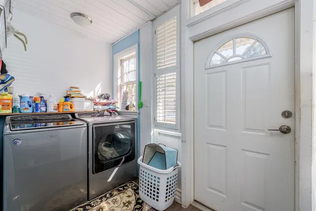 a bedroom with furniture and a large window