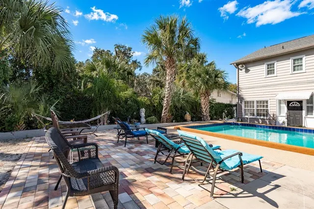 a aerial view of a house with a yard table and chairs