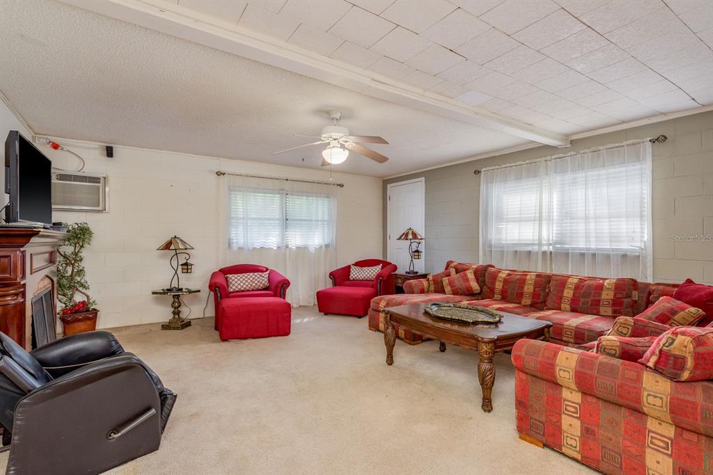 1111 West Line Street Leesburg, FL 34748 - Photo 56 of 77 a living room with furniture a flat screen tv and a window