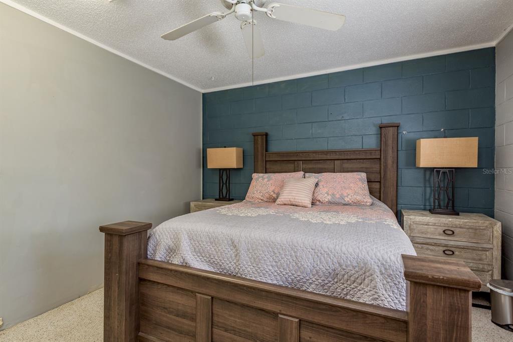 1111 West Line Street Leesburg, FL 34748 - Photo 62 of 77 a bedroom with a bed and a tv