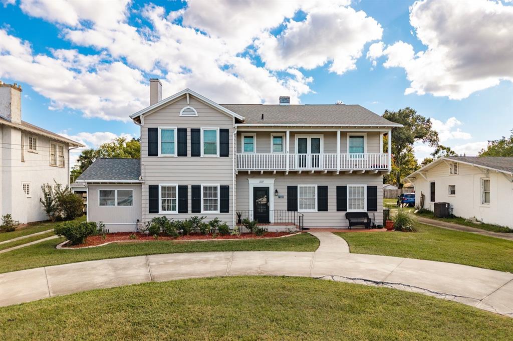 1111 West Line Street Leesburg, FL 34748 - Photo 65 of 77 a view of a white house with a swimming pool and a yard