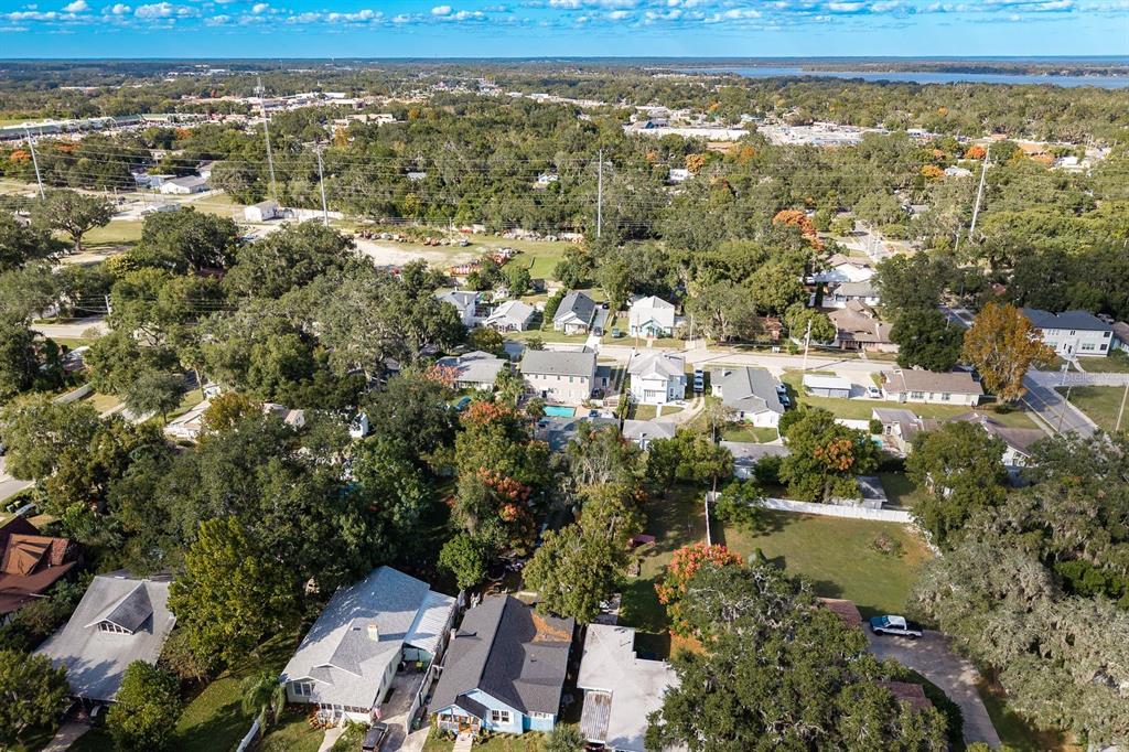 1111 West Line Street Leesburg, FL 34748 - Photo 74 of 77 an aerial view of residential houses with outdoor space and trees