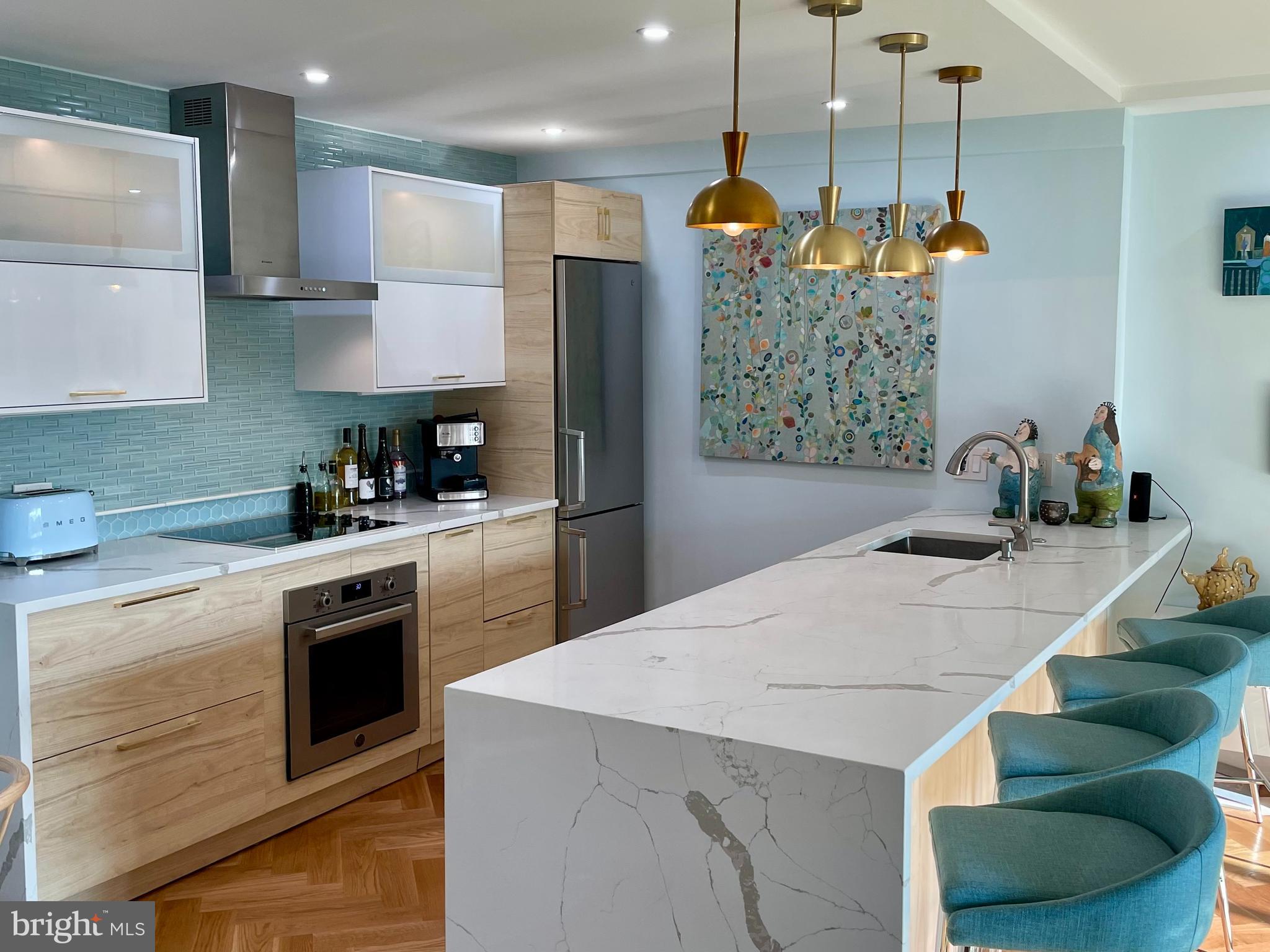 510 N Street Southwest, Unit N526 Washington, DC 20024 - Photo 2 of 9 a kitchen with stainless steel appliances kitchen island granite countertop a sink a stove and a refrigerator